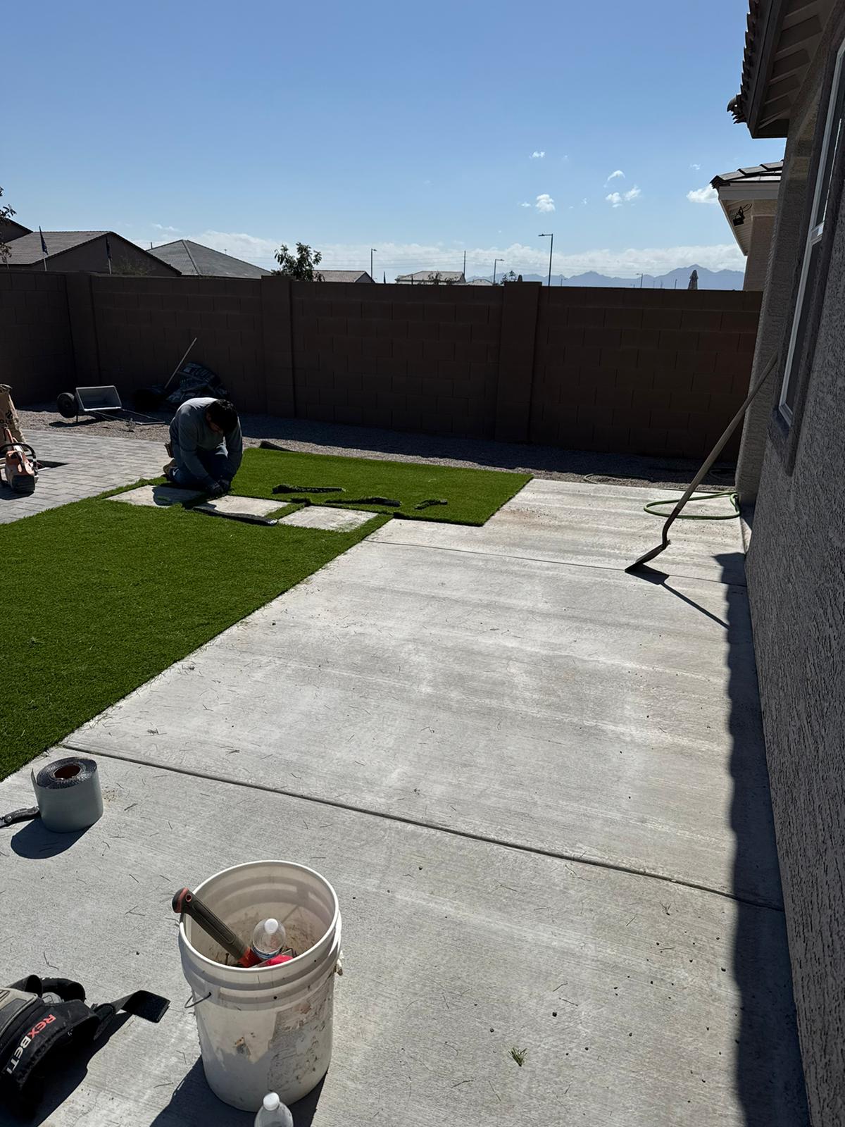 Uriel's Landscaping crew installing turf and concrete in a Tucson backyard